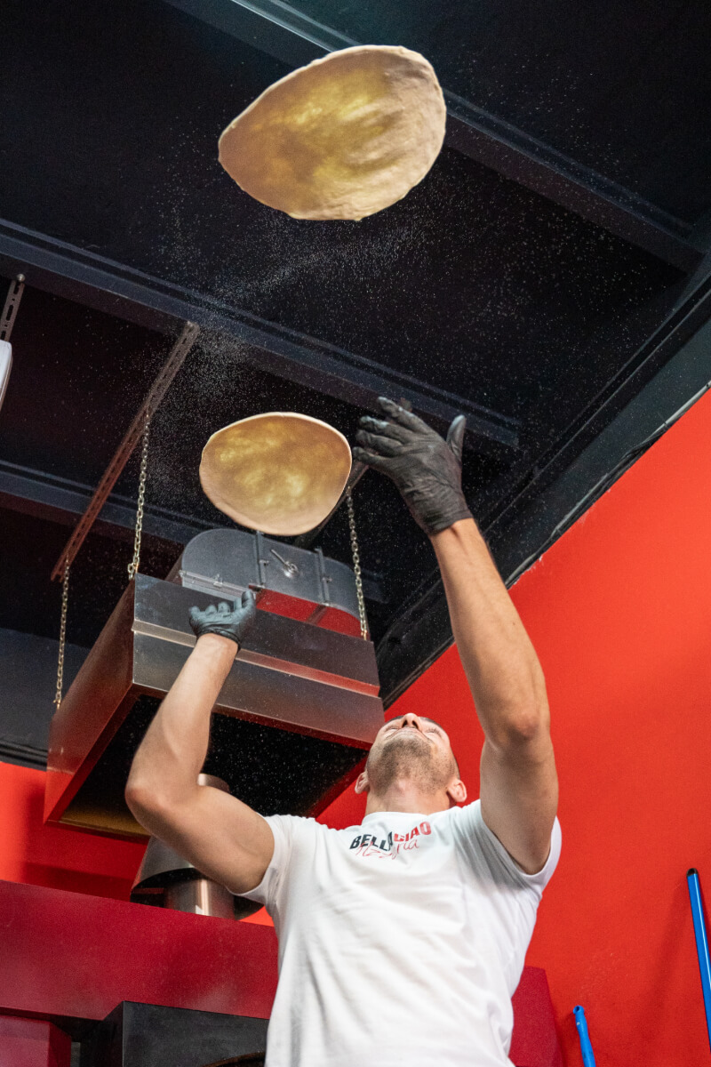 Master pizzaiolo crafting artisan pizza